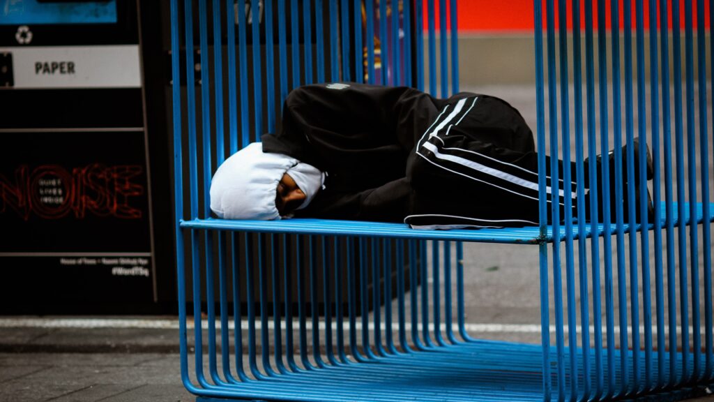 A homeless person sleeping outside.